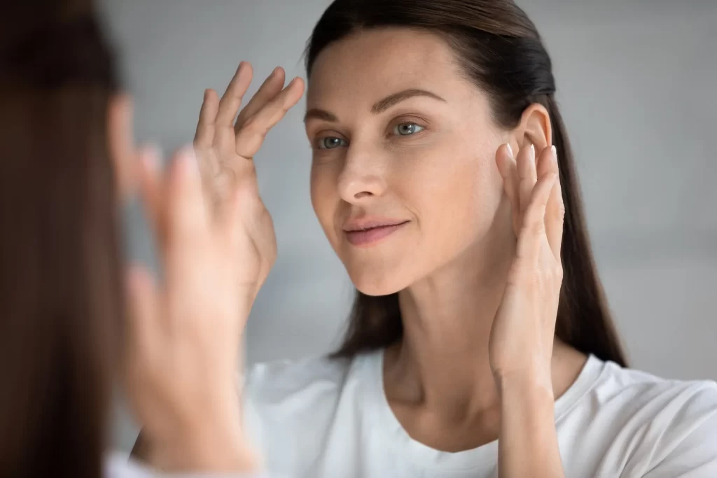 Woman looking at herself in the mirror