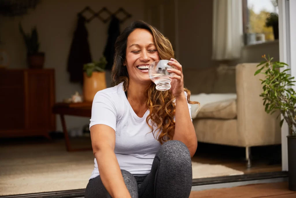 Woman holding glass of water