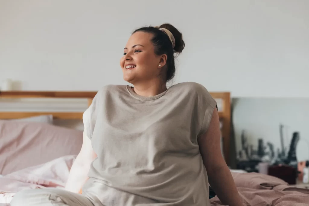 Woman sitting on bed