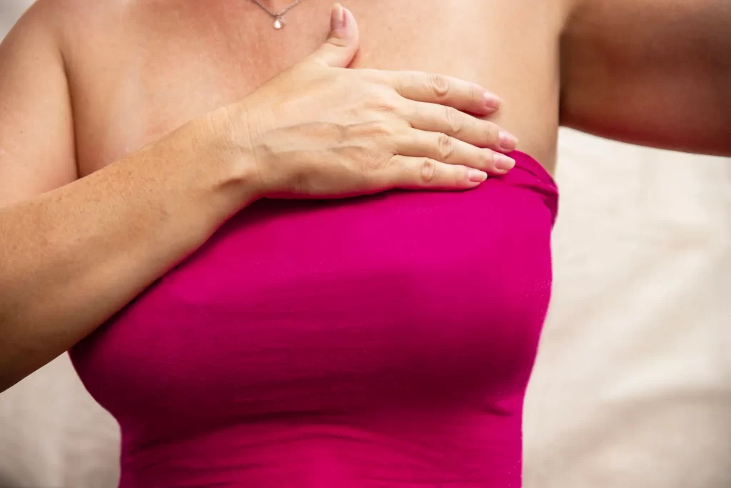 Woman with hand over breast